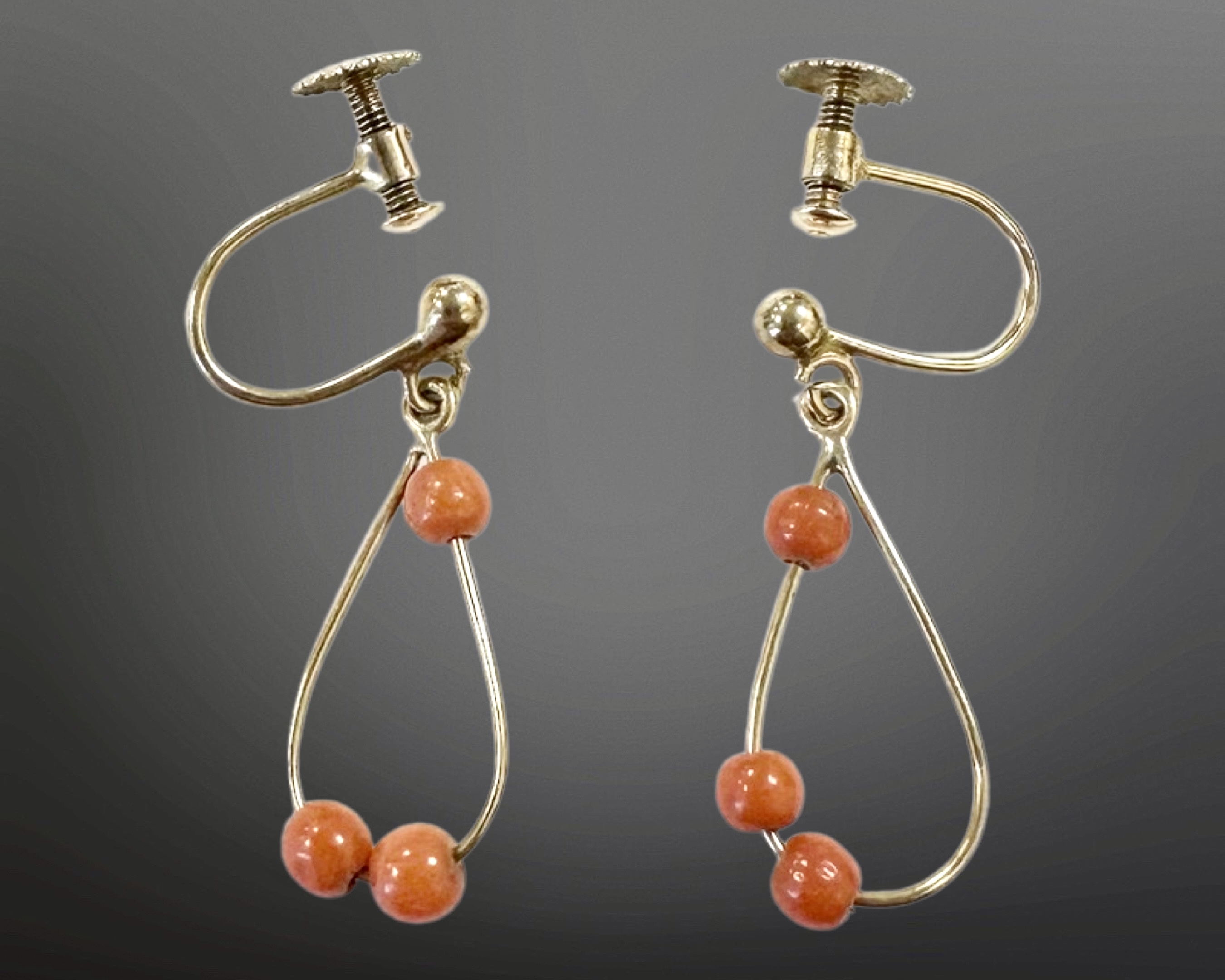 A pair of 9ct gold coral earrings with screw backs. CONDITION REPORT: 1.