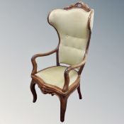 A 19th century continental open wingback armchair