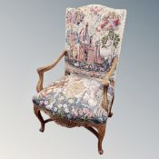 A 19th century French carved beech armchair in tapestry fabric