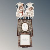 Two Victorian pottery figures of seated children together with a metal photo frame and a