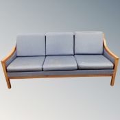 A 20th century wooden framed Danish three seater settee in blue fabric