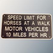 A cast iron wall plaque, speed limit notice.