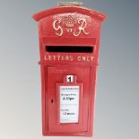 A cast iron George VI style postbox with keys.