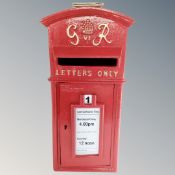 A cast iron George VI style postbox with keys.