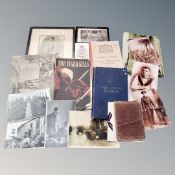 A basket containing World War II ephemera including postcards, monochrome photographs, books,