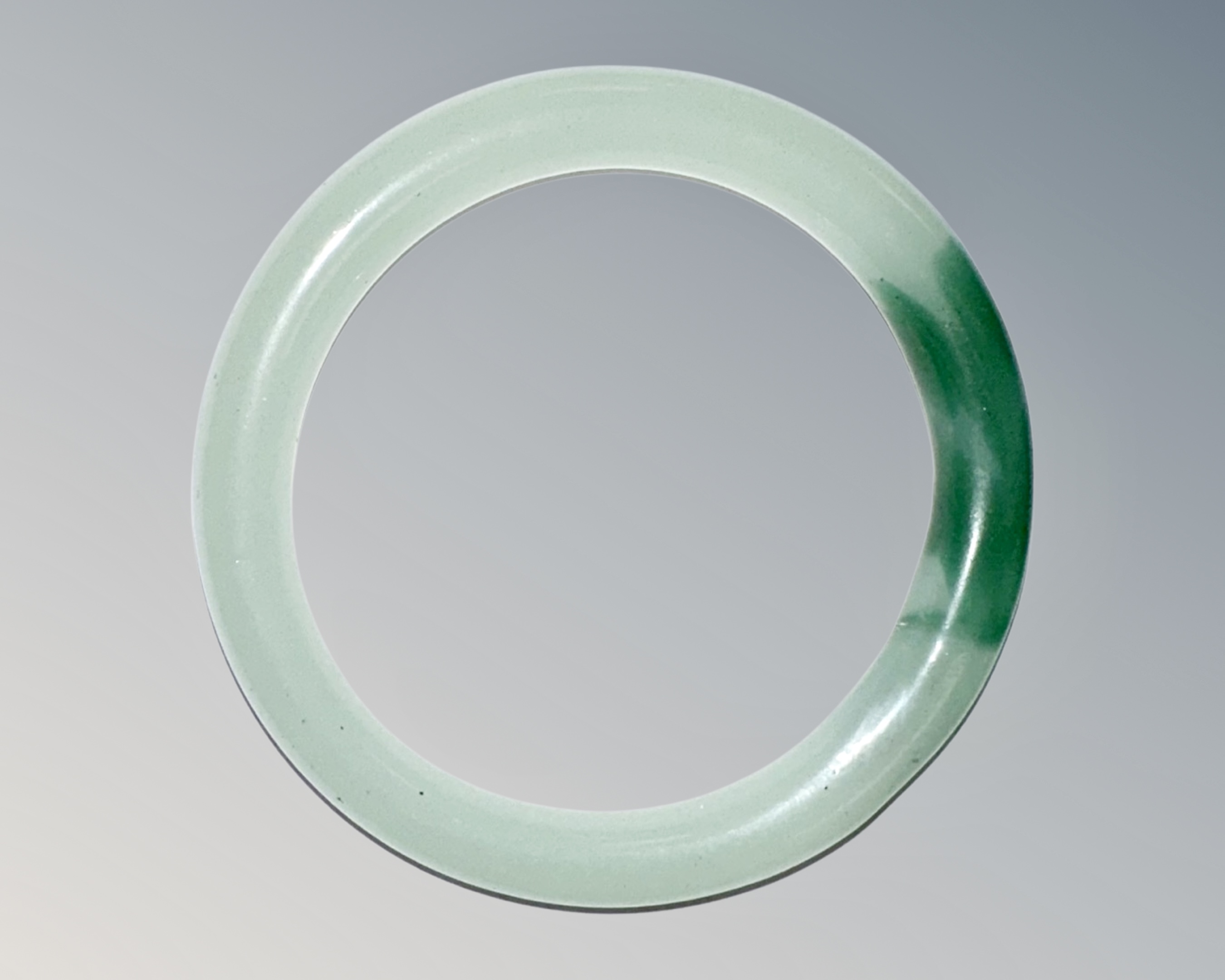 A carved jade circular bangle, inner diameter 58mm.