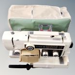 A New Home Combi 10 electric sewing machine with foot pedal and cover