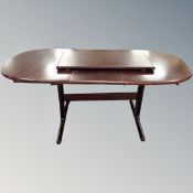 A 20th century Danish extending dining table with two leaves in mahogany finish