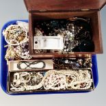 A tray containing a 19th century mahogany table box and a large quantity of costume jewellery.