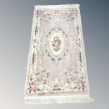 A Chinese embossed fringed rug,