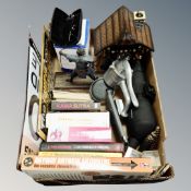 A box of miscellany to include Maginon spotting scope, books, contemporary tin signs,