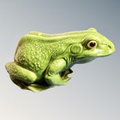 A glazed ceramic garden frog ornament,