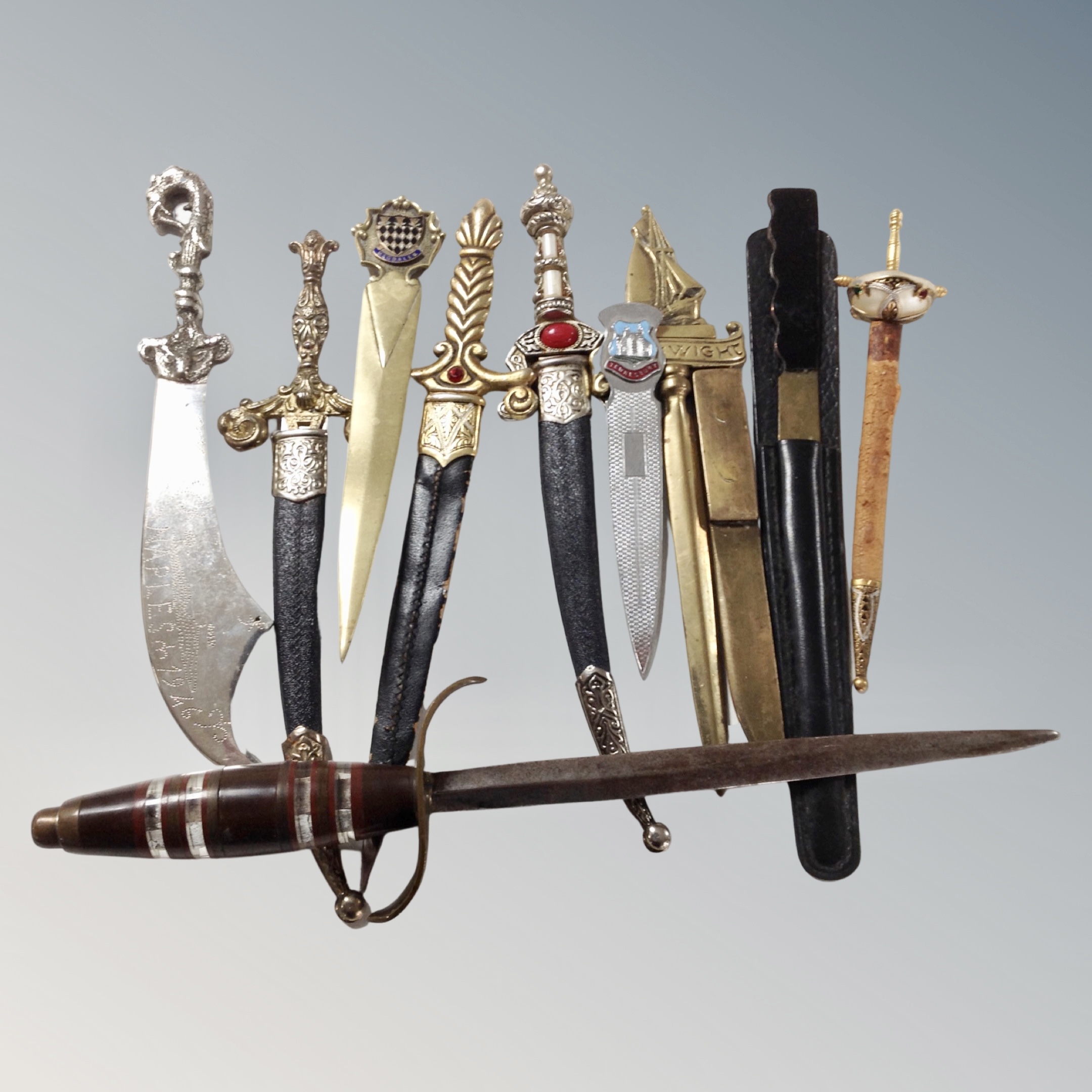 Assorted paper knives and letter openers, most in the form of Eastern swords and knives.
