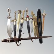 Assorted paper knives and letter openers, most in the form of Eastern swords and knives.