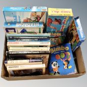 A box containing 20th century children's annuals, reference books, games, a mini Western train set.