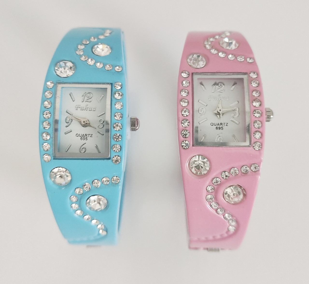 New lady's pink and blue metal watches with diamante quartz crystals together with gold plated box