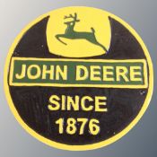 A cast iron wall plaque, John Deere.