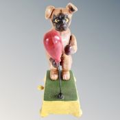 A cast iron mechanical novelty boxing dog toy.
