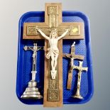 Two wall mounted crucifixes together with two further metal table crucifixes.