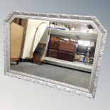 A silvered overmantel mirror