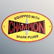 A cast iron wall plaque, Champion spark plugs.