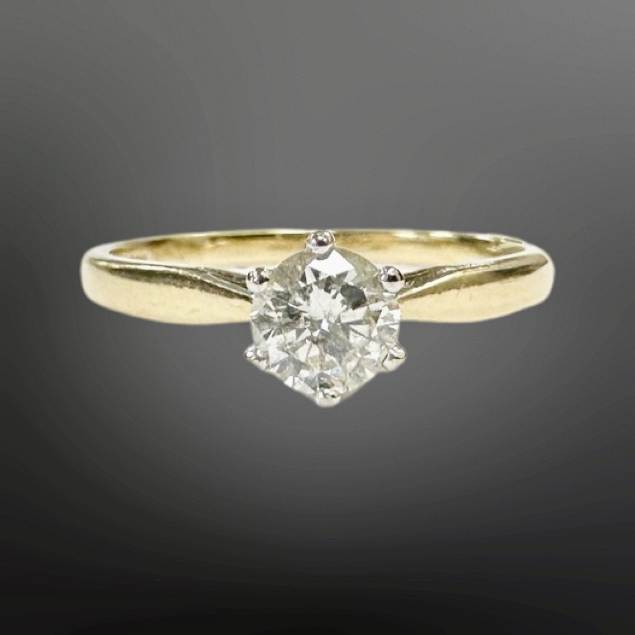 An 18ct yellow gold solitaire diamond ring, the brilliant-cut stone weighing approximately 0.