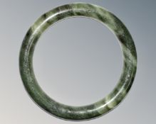 A carved jade circular bangle, inner diameter 58mm.