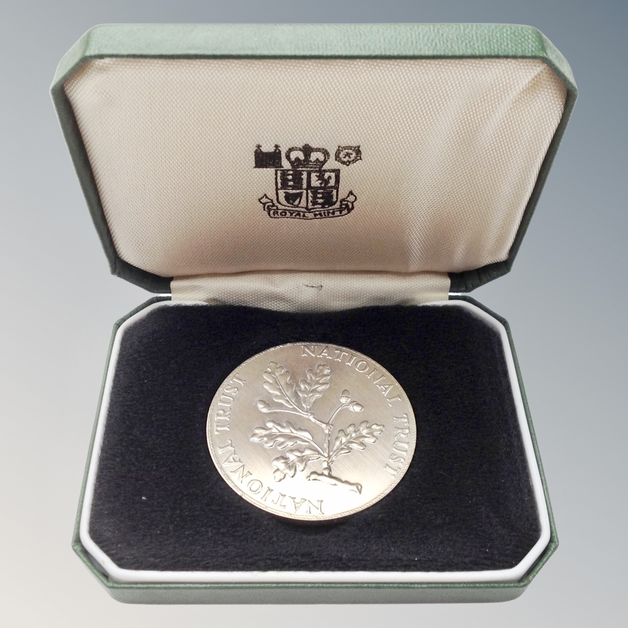 A silver National Trust coin, in box of issue.