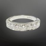 An 18ct white gold seven stone diamond half-eternity ring, the total diamond weight estimated at 1.