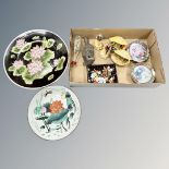 Two oriental plates and a box containing similar figures,