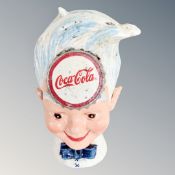 A cast iron novelty Coca-Cola money box.