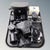 A tray containing cased Boots Pacer 8x30 field glasses, Minolta XG-M camera, Canon AE-1 camera,