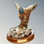 A Royal Doulton kingfisher on plinth, overall height 23cm.