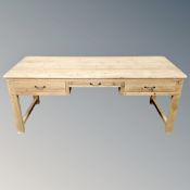 A contemporary pine farmhouse style preparation table fitted with three drawers