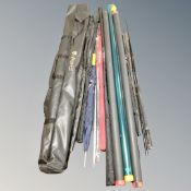 An Aegis rod bag contianing assorted fishing rods to include Shakespeare two-piece fly rod,