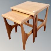 A nest of two 20th century teak tables