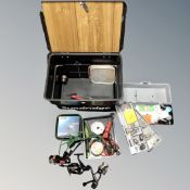 A Sundridge fishing tackle box containing assorted reels and fishing tackle