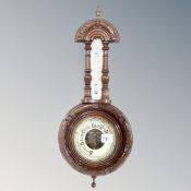 An antique carved wall barometer.
