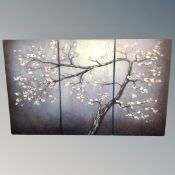 A triptych wall canvas depicting a blossom tree together with further canvas pictures