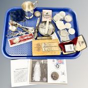 A tray containing crowns including one in silver mount, loose cutlery plated Christening mug,