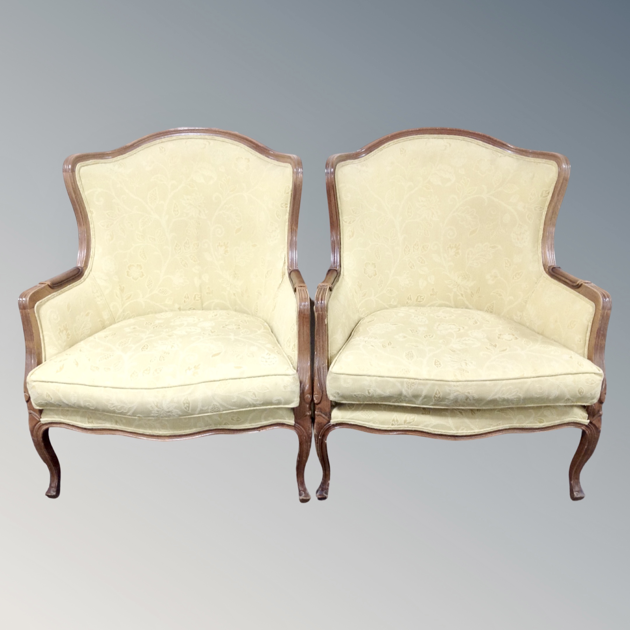 A French style beech framed armchairs upholstered in floral fabric