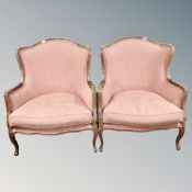 A pair of French style beech framed armchairs upholstered in salmon fabric