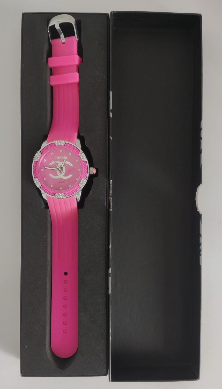 Quartz watch with pink face and silver bling.