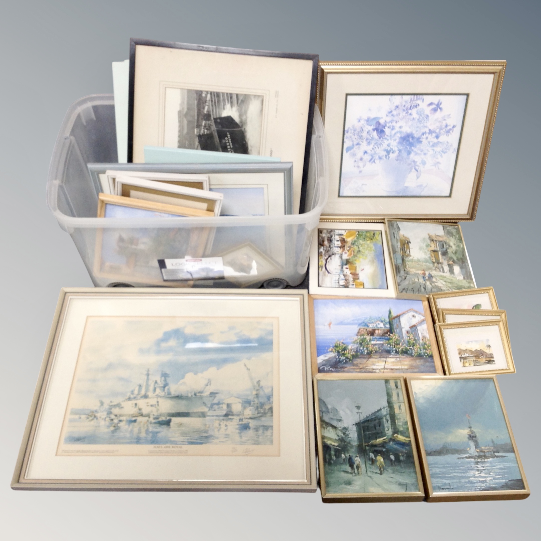 A crate of assorted pictures and prints,