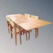 A 20th century Danish teak extending dining table with four chairs