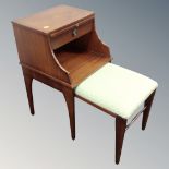 A telephone table with pull out stool in a mahogany finish