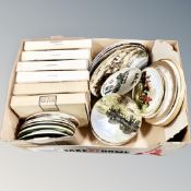 A box of collectors plates, boxed and unboxed.