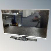 A Samsung 32 inch LCD TV with remote