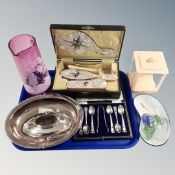 A tray of cased teaspoons and tongs, cased three-piece dressing table set, enamelled bowl, eye bath,