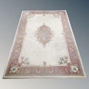 An Indian hand knotted woolen rug on cream ground 154 cm x 235 cm